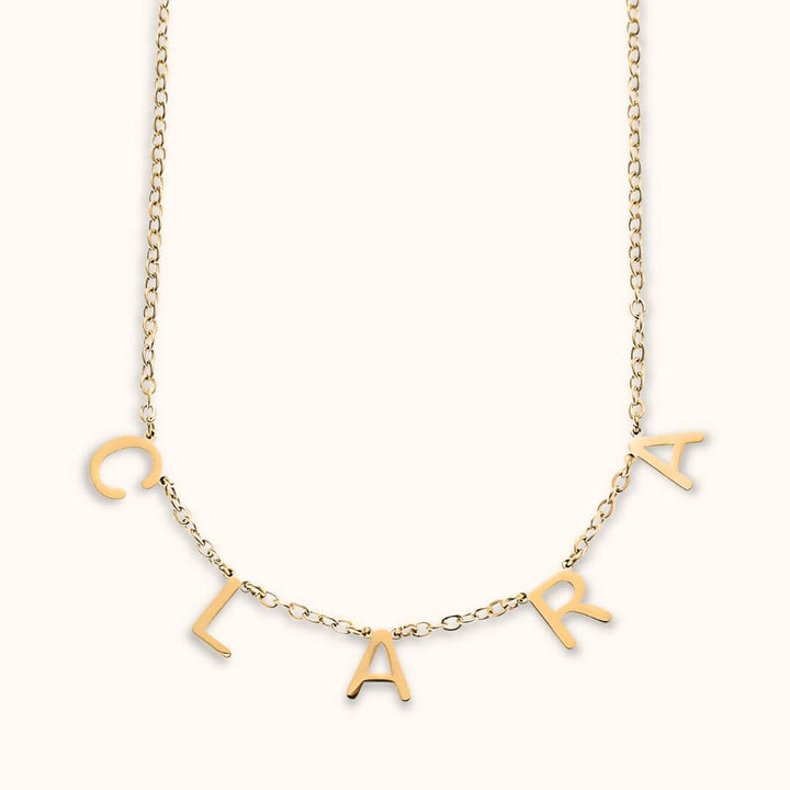 Gold dainty letter name necklace featuring custom letters spelling 'Clara,' perfect for personalized jewelry lovers.