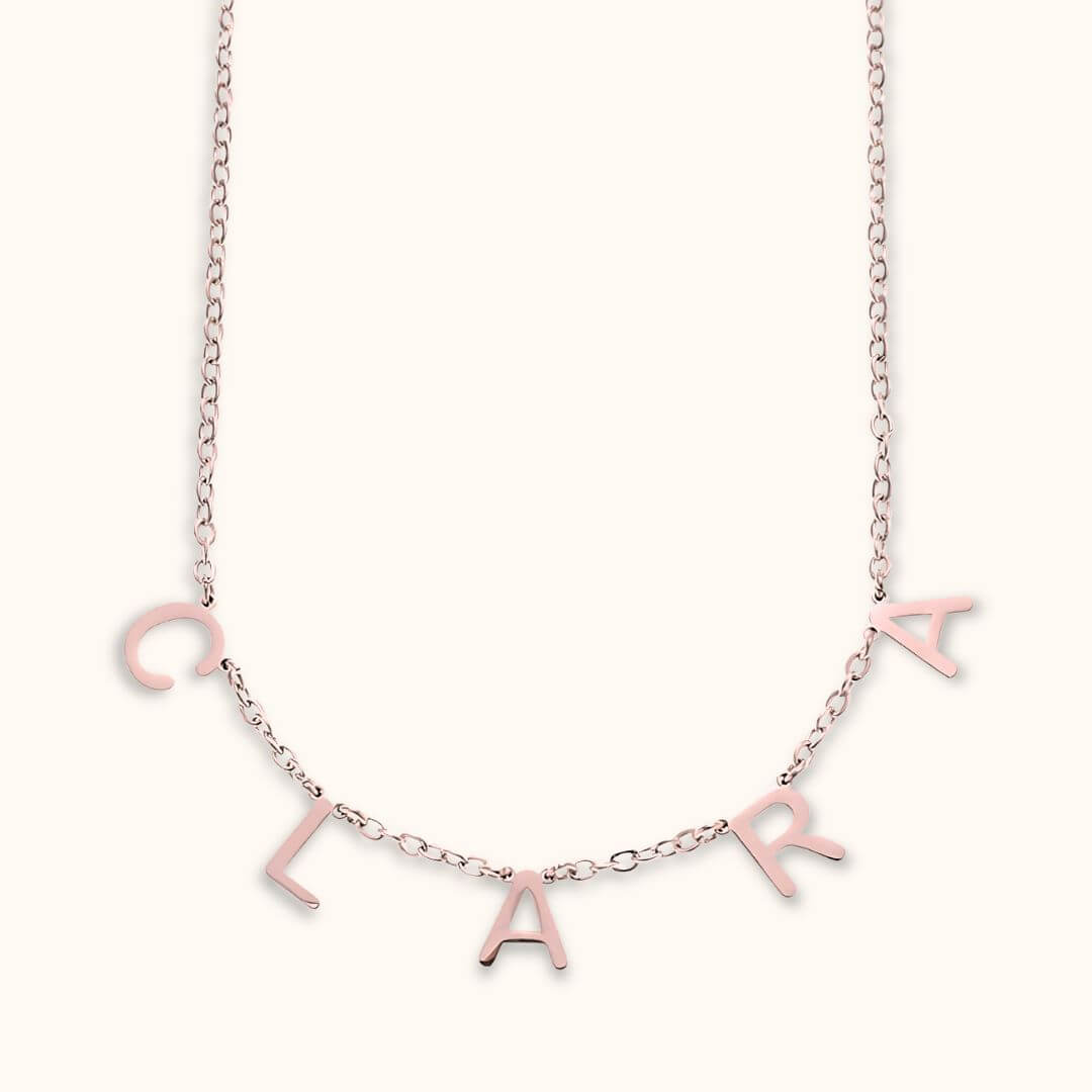 Rose gold letter name necklace with custom dainty letters spelling 'Clara,' a stylish and unique personalized gift.