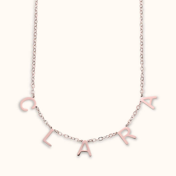 Rose gold letter name necklace with custom dainty letters spelling 'Clara,' a stylish and unique personalized gift.