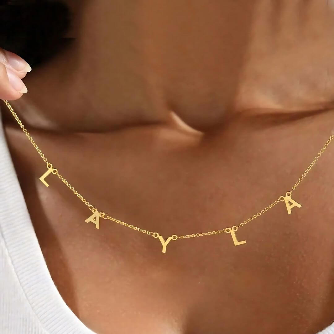 Gold letter name necklace styled with 'Layla,' a chic custom accessory for minimalistic and trendy looks.