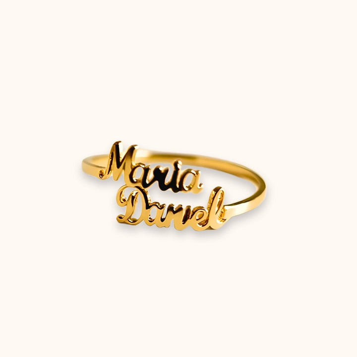 Gold double name ring with 'Maria' and 'Daniel' engravings, showcasing a sleek and modern customizable design.