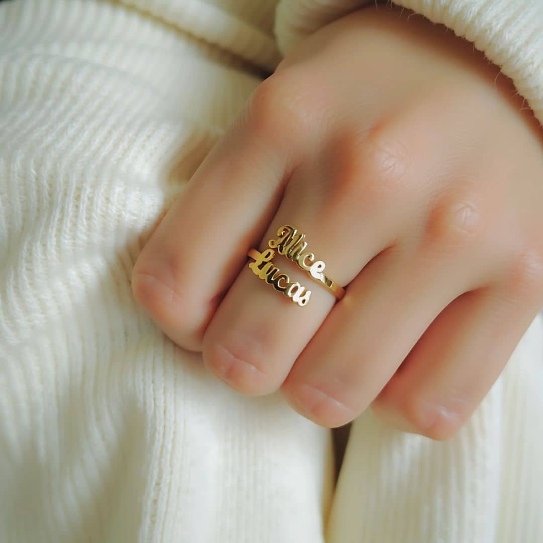 Gold double name ring engraved with 'Alice' and 'Lucas,' stylishly worn on a hand, perfect for gifting or daily wear.