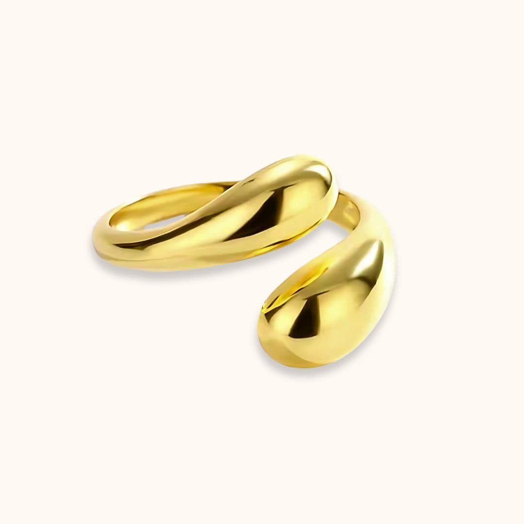 Shiny gold Open Teardrop Dome Ring placed alone on a light background, emphasizing its smooth, reflective finish and versatile, high-quality craftsmanship.