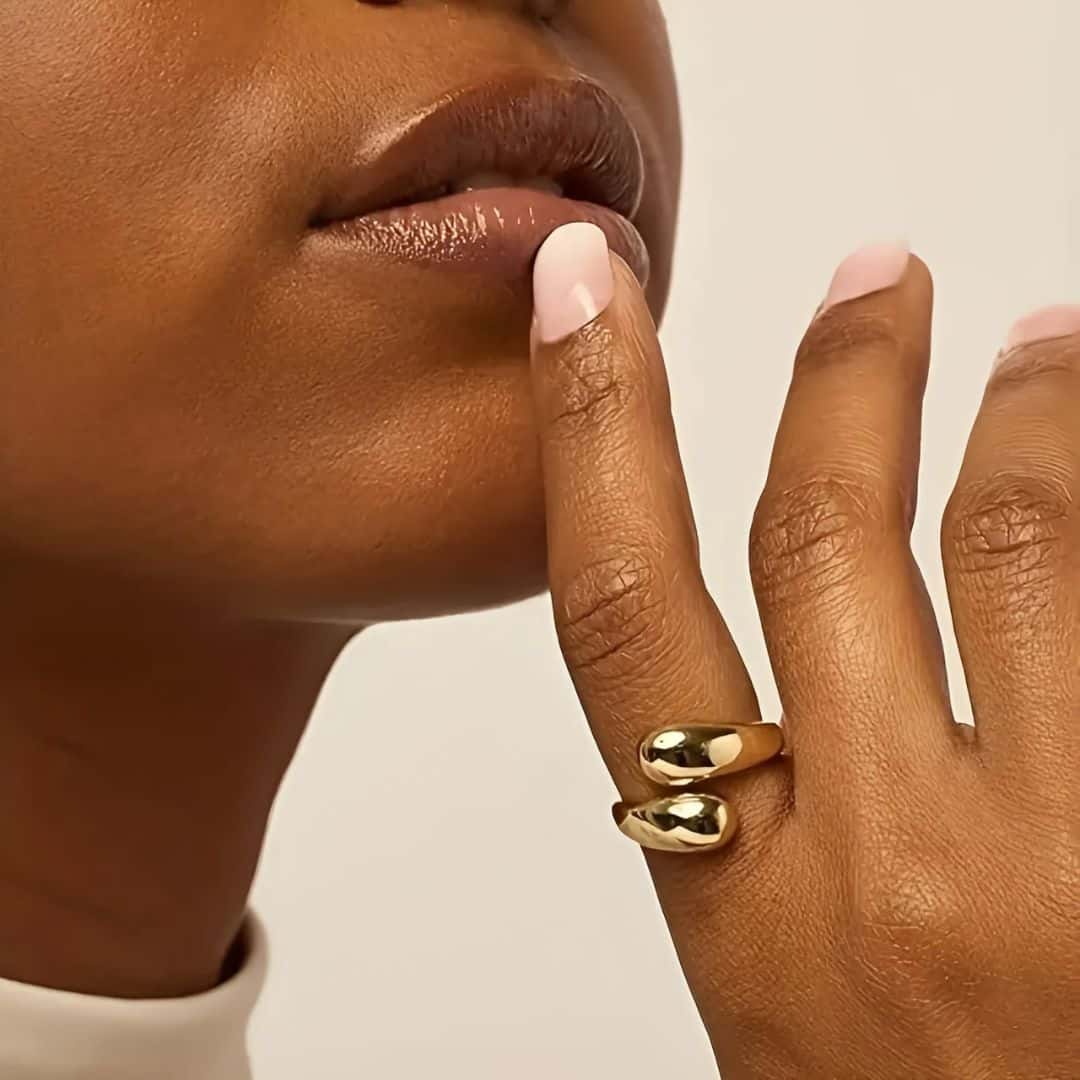 Close-up of a model wearing the Open Teardrop Dome Ring, showcasing its unique open teardrop shape and timeless style, perfect for layering or standalone elegance.